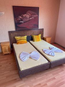 two beds with bows on them in a room at ТРАКАРТ-ПАРК in Plovdiv