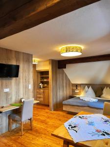 a bedroom with a bed and a desk and a table at Bio-Bauernhof Simonbauer in Ramsau am Dachstein