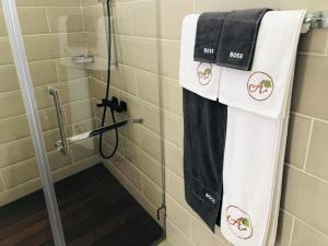 a bathroom with a shower with towels on it at Amontana Luxury Hôtel in Antananarivo