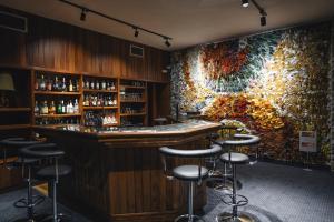 a bar with a large painting on the wall at Zespół Tatry - Hotel Tatry i Budynek Turystyczny in Murzasichle