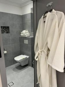 a bathroom with a toilet and a towel on a rack at Vila Niki in Sovata