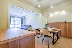 a kitchen and dining room with a table and chairs at Stunning 2BDR Condo on Historic Location in Center in Sofia +29 photos
