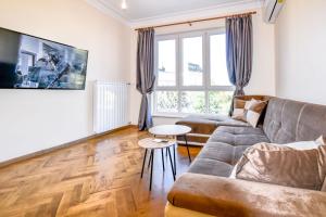 a living room with a couch and a table at Stunning 2BDR Condo on Historic Location in Center in Sofia