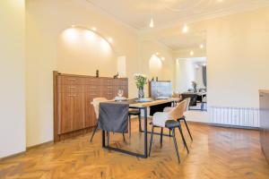 a dining room with a table and chairs at Stunning 2BDR Condo on Historic Location in Center in Sofia