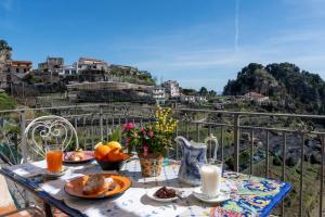 a breakfast table with food on a balcony with a view at Ferriere Apartment in Scala