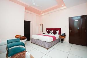 a hotel room with a bed and a chair at Agariya Haveli near Pichola Lake, Udaipur in Udaipur +39 photos