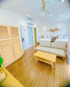 a bedroom with a bed and a couch and a table at Z Homestay 2 Phú Quốc in Phu Quoc