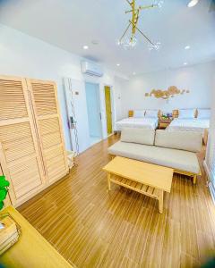 a bedroom with a bed and a couch and a table at Z Homestay 2 Phú Quốc in Phú Quốc