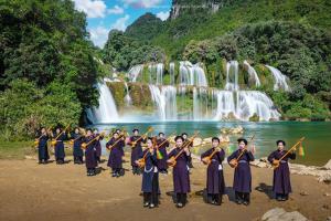 a group of people standing in front of a waterfall at Minh Khang Homestay - Làng đá cổ Khuổi Ky in Cao Bằng +27 photos