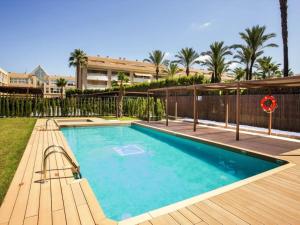 a swimming pool with a bench next to a wooden deck at Beach House Jávea - Penthouse with Private Rooftop Terrace in Jávea