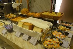 a buffet of bread and pastries on a table at Crowne Plaza Zhongshan Wing On City, an IHG Hotel in Zhongshan