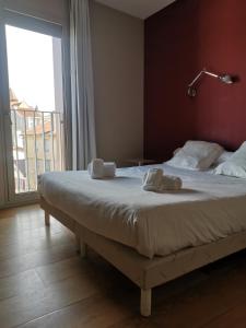 a bed in a room with a large window at Temporesidence Cathedrale in Bayonne