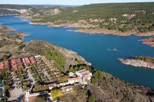 an aerial view of a house on a hill next to a lake at Kampaoh Oliva in Oliva