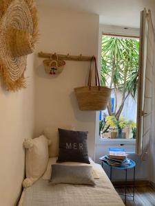 a bedroom with a bed and a window and a basket at Jolie studette avec Patio style Cabanon in Marseille