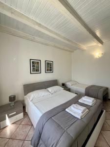 a bedroom with two beds in a room at Residence la Lucciola in Lonato +61 photos