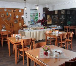 a restaurant with wooden tables and chairs and a counter at Hotel Nezih Istanbul in Istanbul