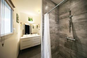 a bathroom with a shower and a sink at L'Océraline - Maison avec jardin et wifi in La Lucerne-dʼOutremer +9 photos