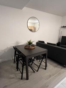 a table in a living room with a mirror at Appartement Dammarie-les-Lys in Dammarie-lès-Lys