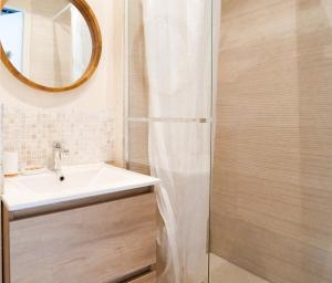 un baño con lavabo y ducha en Appartement rénové avec goût et idéalement situé à deux pas du remblai, en Les Sables-dʼOlonne