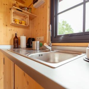 a kitchen counter with a sink and a window at Ecau Lodge - Logement insolite à 30km de Pairi Daiza in Écaussinnes-dʼEnghien