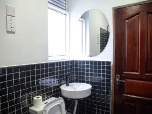 a bathroom with a sink and a mirror at Explorers Hub in Kampala