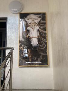 a picture of a horse hanging on a wall at Golden Horse Hotel in Taldykorgan