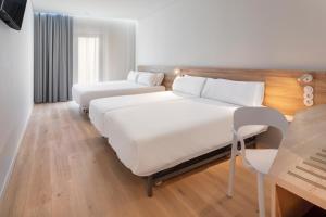 a hotel room with a bed and a couch at B&B HOTEL Olhão Algarve in Olhão +17 photos