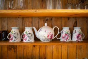 a group of four vases on a shelf at Lavington Johnston in Johnston