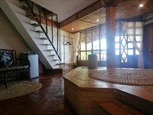 a living room with a spiral staircase in a house at VILLA MARMARINE BEACH RESORT & RESTAURANT in Siquijor