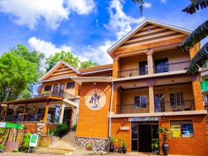 an orange brick building with a staircase in front of it at Explorers Hub in Kampala