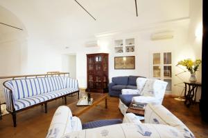 a living room with couches and a blue couch at La Madonetta - Dimora d'epoca - in Levanto