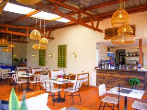 a restaurant with tables and chairs and a bar at Explorers Hub in Kampala