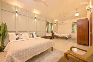 a bedroom with a bed and a living room at EKO STAY- Brickstone Villa in Igatpuri