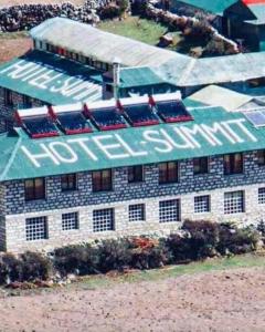 a building with a sign on the side of it at Hotel Summit in Dingboche