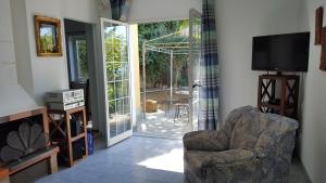 a living room with a chair and a sliding glass door at SB Bed & Breakfast in Seborga