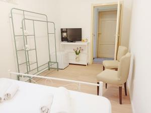 a bedroom with a bed and a mirror and a tv at Maride Holiday in Noto