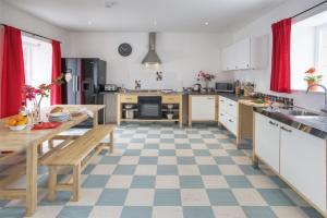 a large kitchen with a checkered floor at Ettrick View in Selkirk