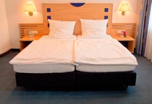 Postel nebo postele na pokoji v ubytování Hotel Krone