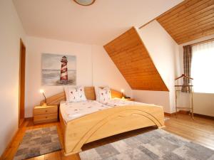 a bedroom with a large bed and a lighthouse at Ferienwohnung Wolfgang in Altenkirchen in Altenkirchen