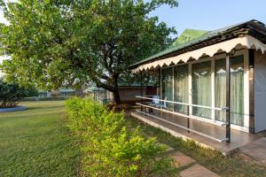 a small house with a tree in a park at Nature Trails Durshet, Khopoli in Khopoli