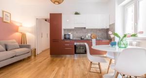 Il comprend une cuisine et un salon avec une table et un canapé. dans l'établissement ALTIDO Delightful Flats Near CityLife District, à Milan