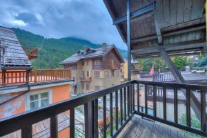 a balcony with a view of a town at Appartamento Rochebrune 200m from Ski - Happy Rentals in Claviere