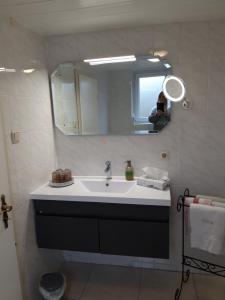 a bathroom with a sink and a mirror at Ferienhaus Gossel in Bad Wildungen
