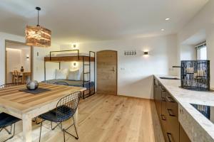 a room with a table and a bunk bed at Stube Biohof Oberzonn in Kastelruth