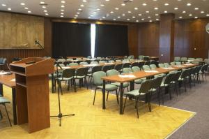 a conference room with tables and chairs and a podium at Hotel Bezdez Stare Splavy in Staré Splavy