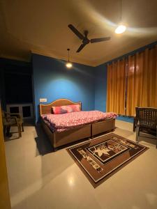 達蘭薩拉的住宿－Alora bhagsu，一间卧室配有一张床和吊扇
