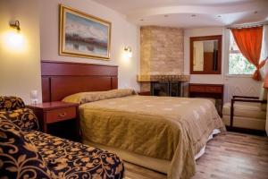 Posteľ alebo postele v izbe v ubytovaní Tasia Mountain Hotel