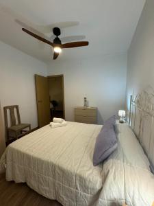 a bedroom with a large bed with a ceiling fan at Apartamento Irene 1 in Caravaca de la Cruz