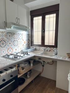 a kitchen with a sink and a stove top oven at Apartamento Irene 1 in Caravaca de la Cruz