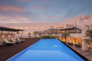 a swimming pool in front of a building at Courtyard by Marriott Bhopal in Bhopal
